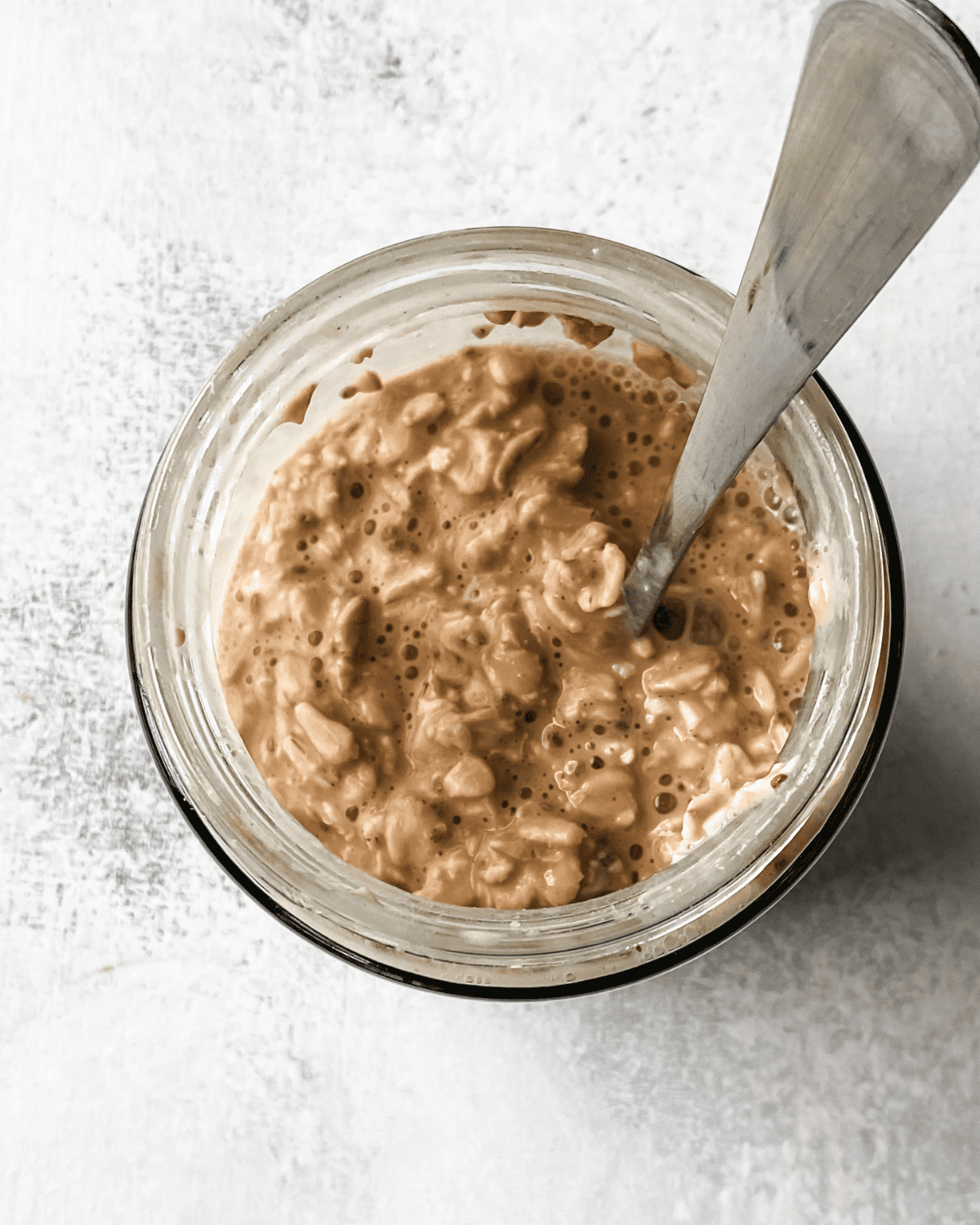 overnight oats with pb2 stirred in mason jar.
