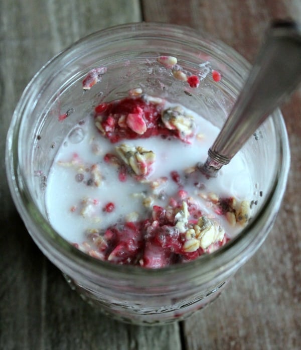 mixing ingredients in a mason jar for overnight oats 