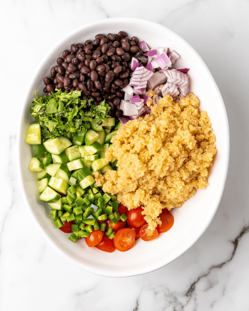 all of the mexican salad ingredients in a white bowl