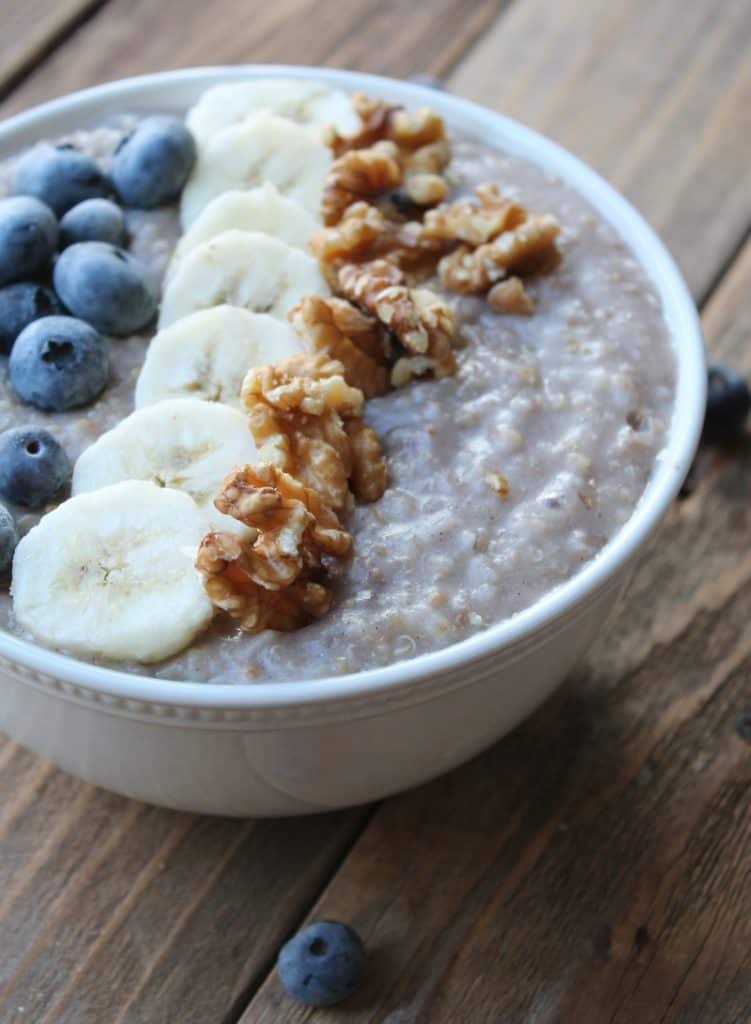 bowl of oatmeal with blueberries bananas and walnuts