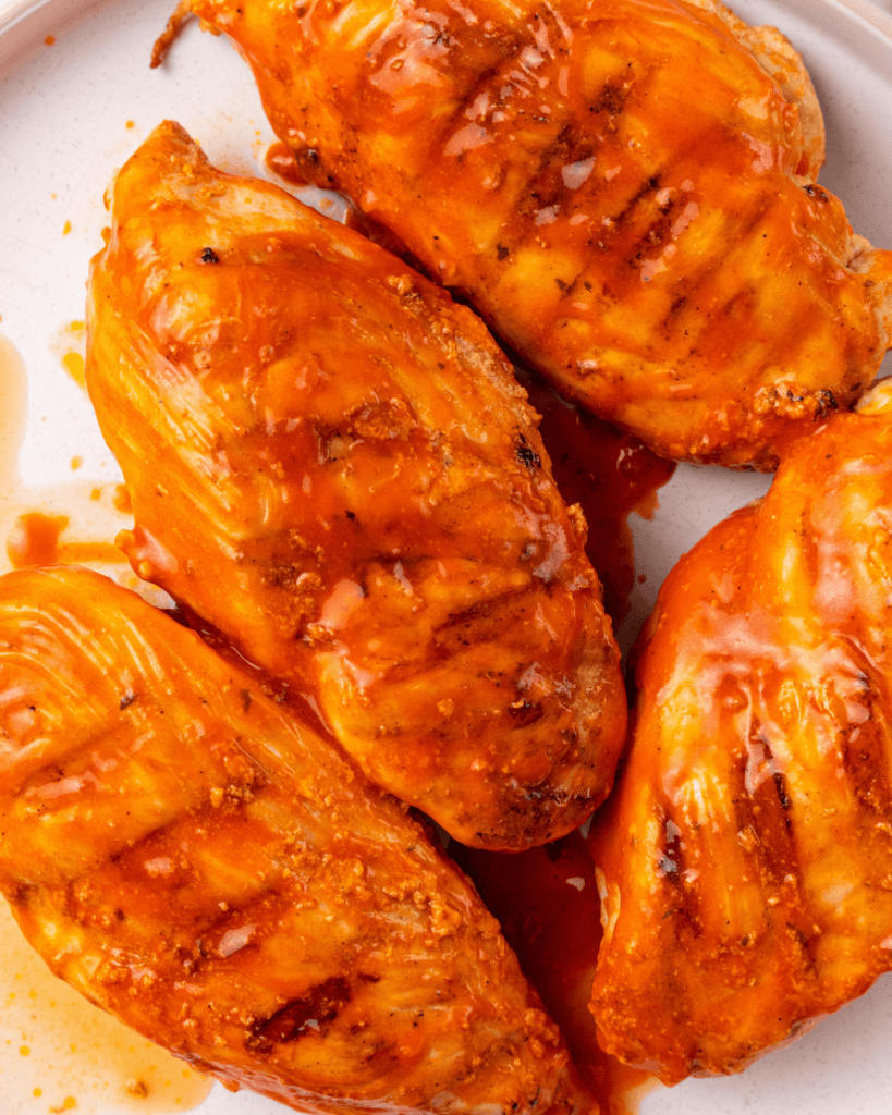 Chicken with hot sauce marinade brushed on it.