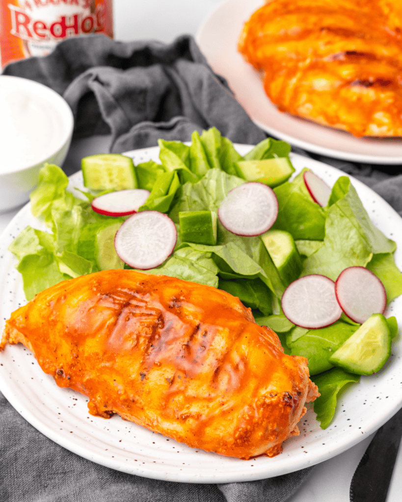 chicken with a salad on a plate.