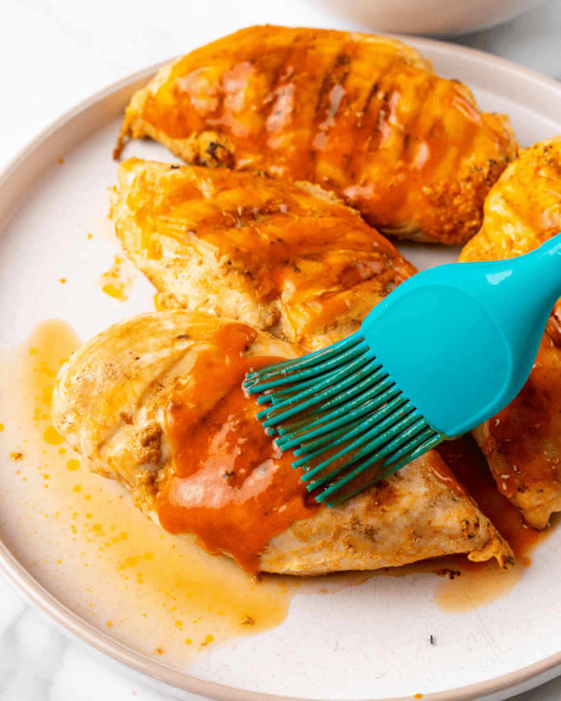 brush hot sauce and butter on the cooked chicken.