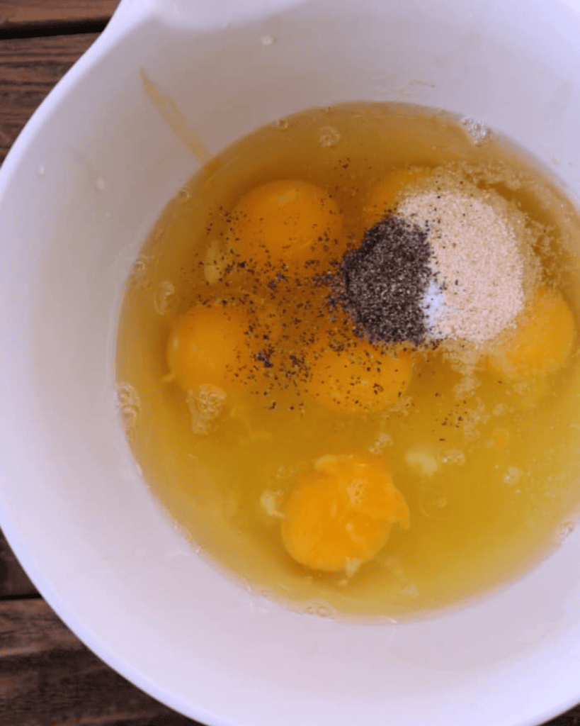 eggs in a bowl with seasoning.