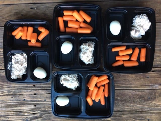 carrots, tuna, and egg in a meal prep container.