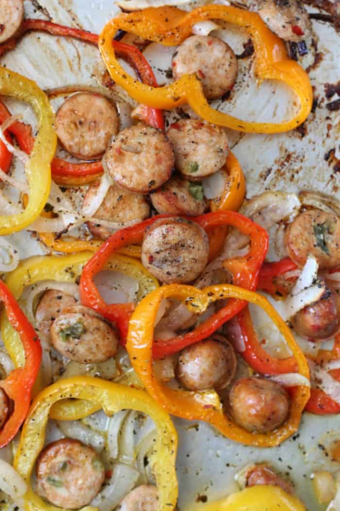 Sausage slices and wedges of peppers and onions roasted.