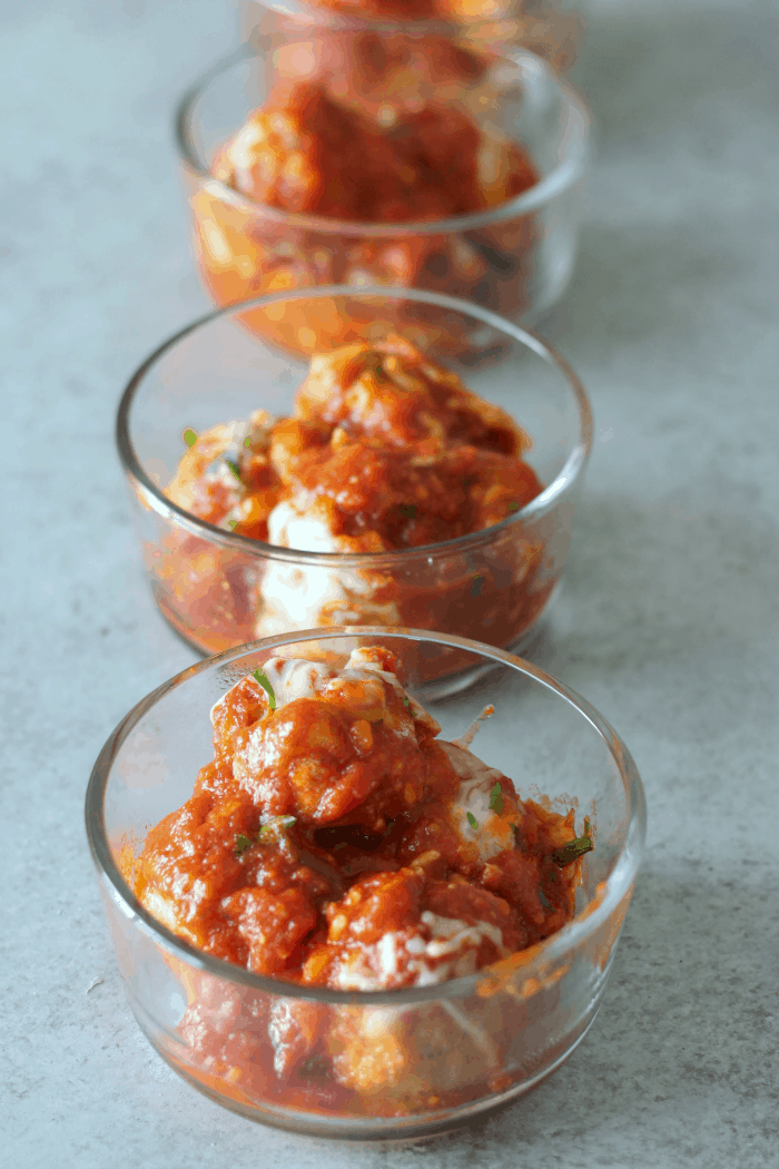 chicken parmesan meatballs portioned out into glass containers.