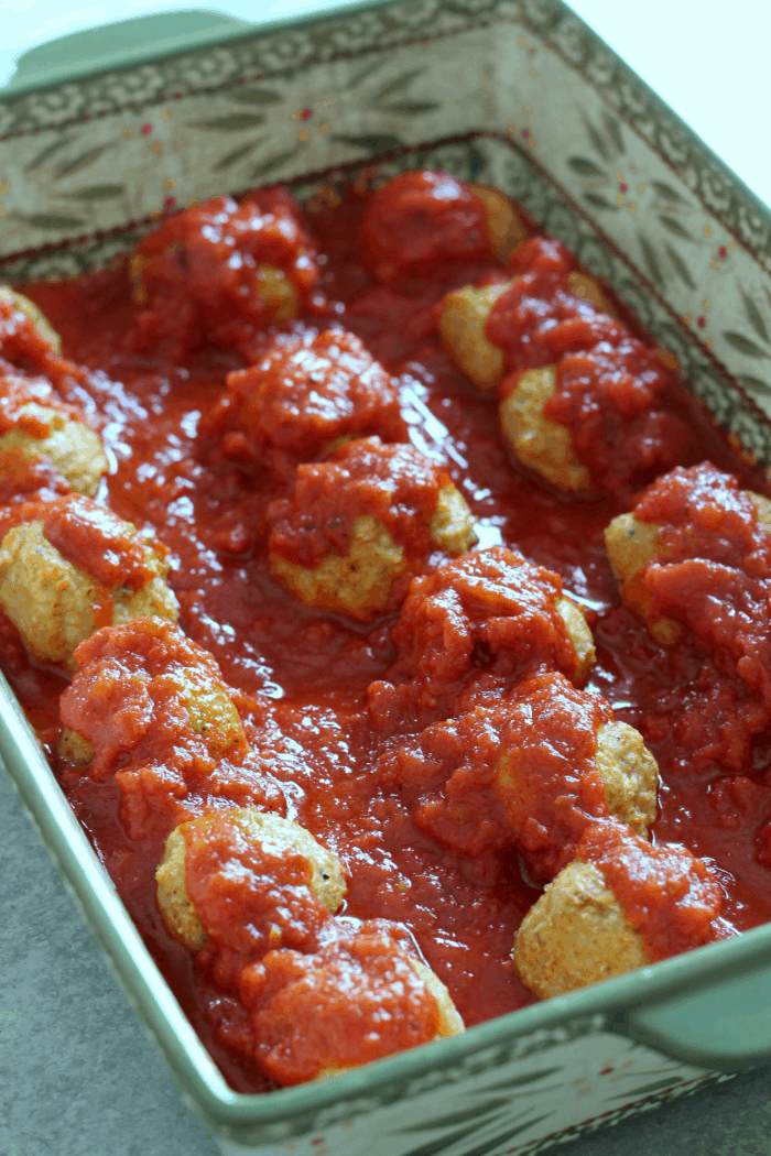 chicken parmesan meatballs smothered in sauce.