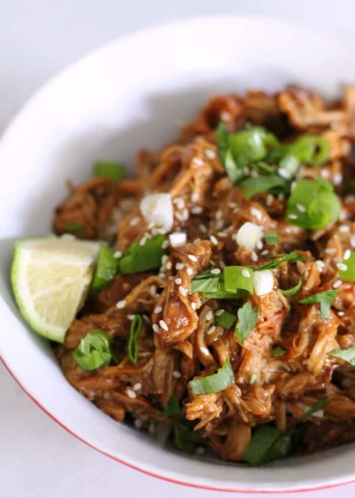 Freezer shredded beef cooked and served in a bowl with a lime wedge.