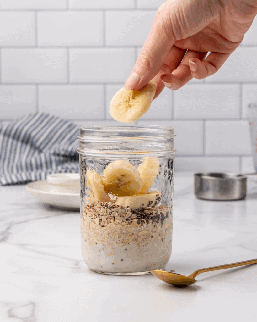adding in the wet ingredients into the mason jar for overnight oats.