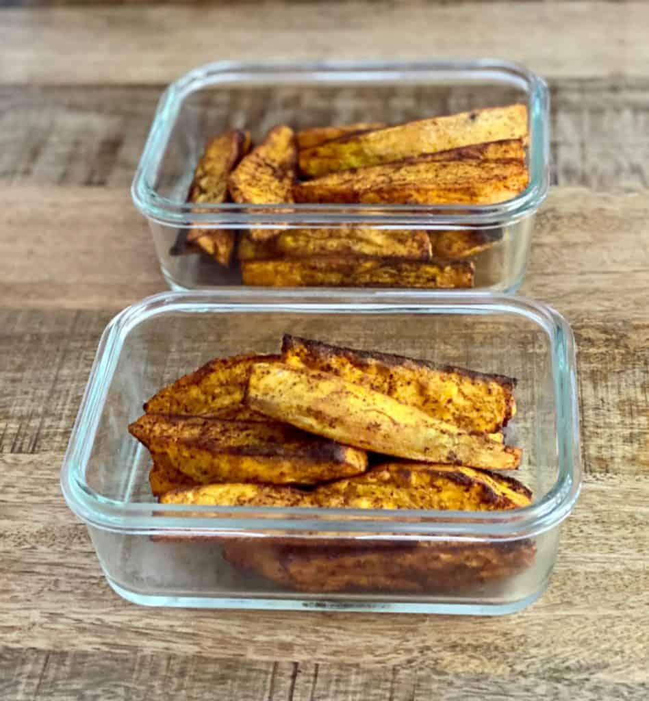 Sweet potato wedges in glass containers for meal prep. 