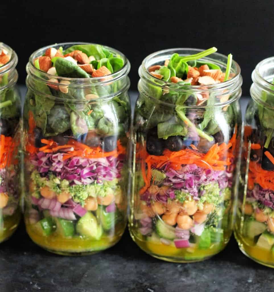 Mason jar salad with layered ingredients as a clean eating meal prep option.