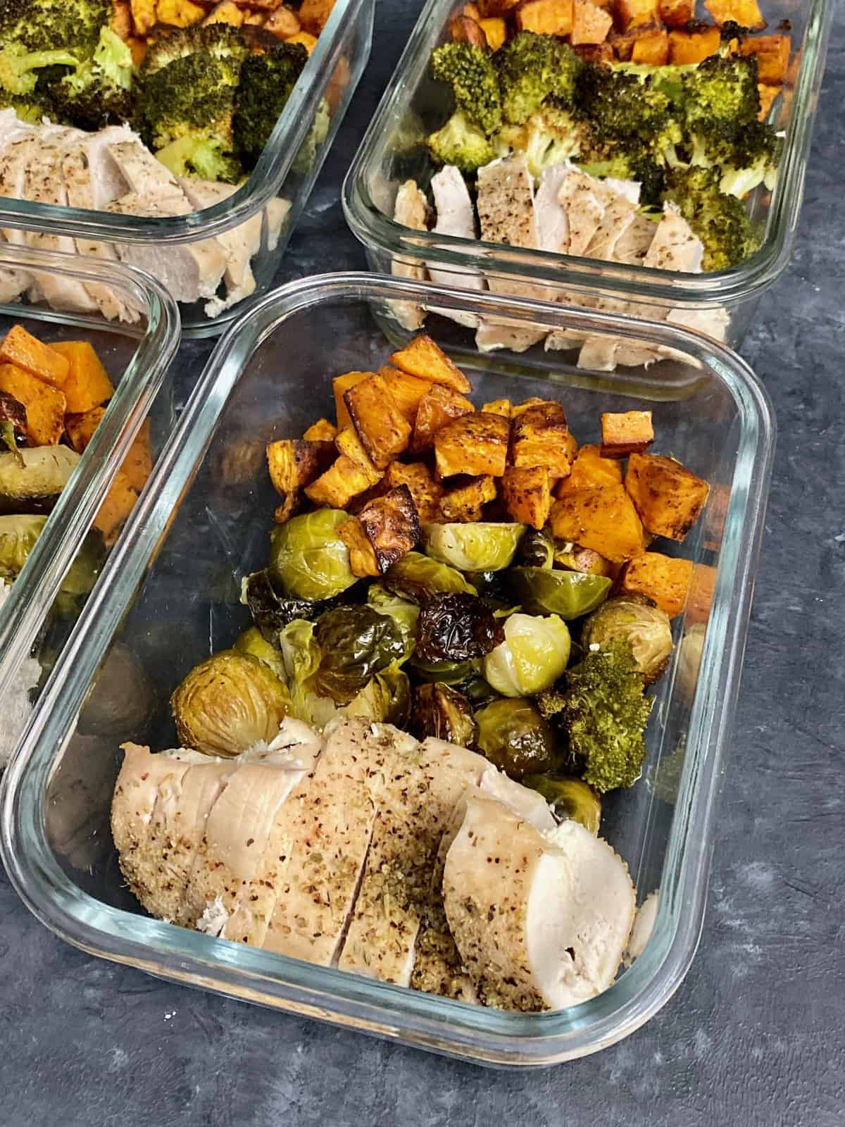 learn to meal prep chicken. Chicken and vegetables in glass containers.