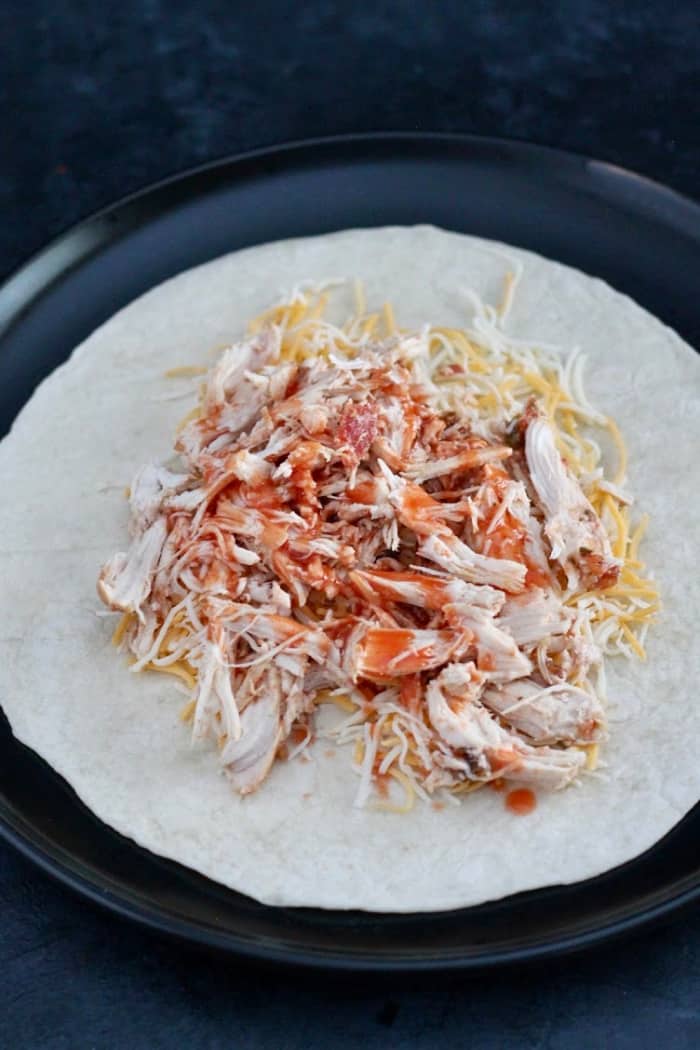 Tortilla with cheese, chicken and salsa to demonstrate how to prep chicken quesadillas ahead of time.