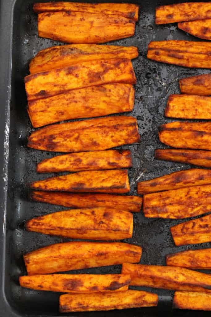 Sweet potato wedges on a baking pan fresh out of the oven.