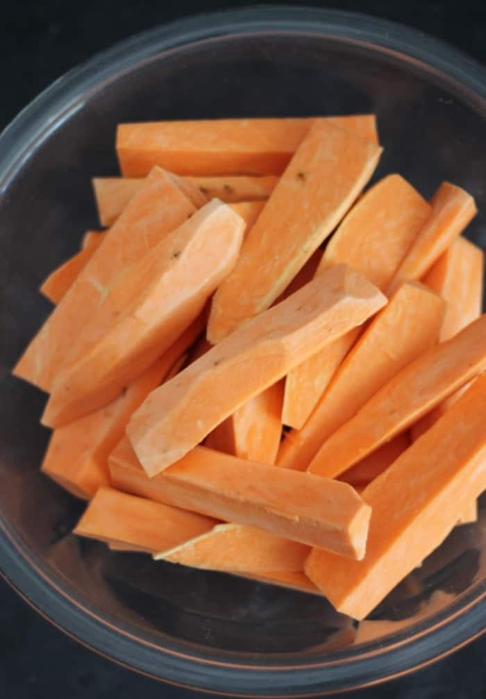 raw sweet potato wedges in a bowl.