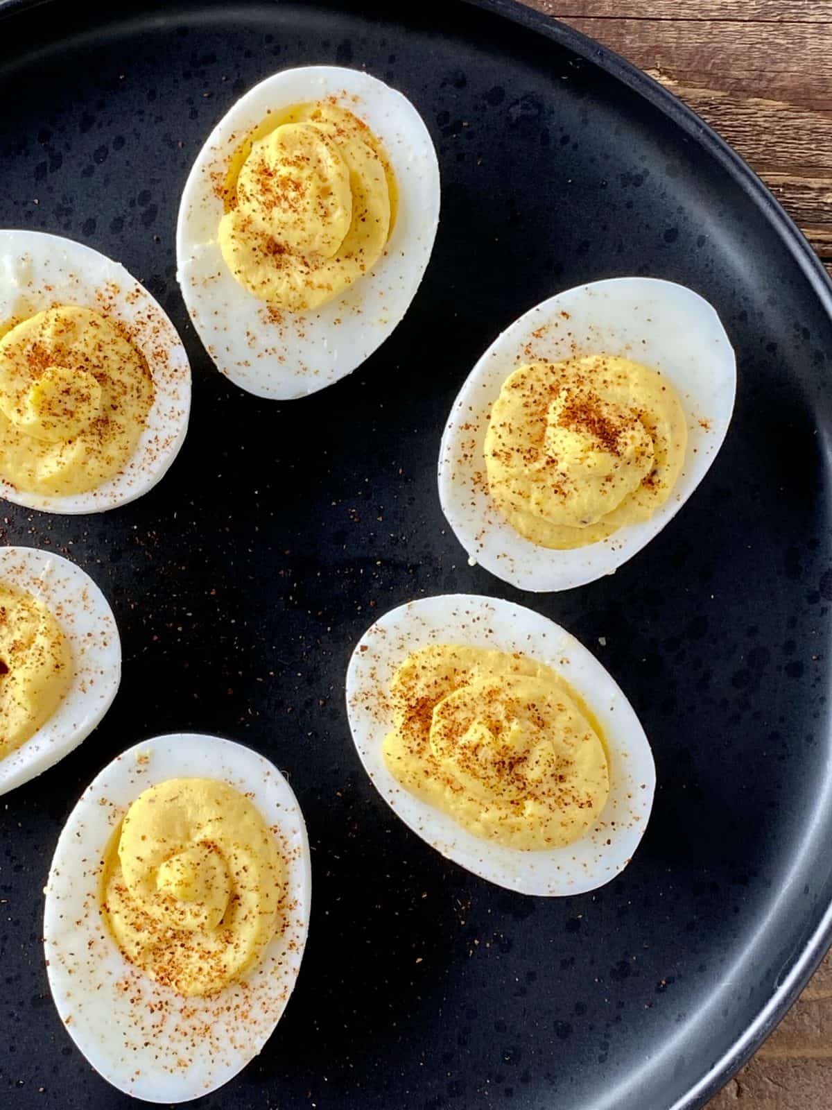 healthy deviled eggs with horseradish on a black plate