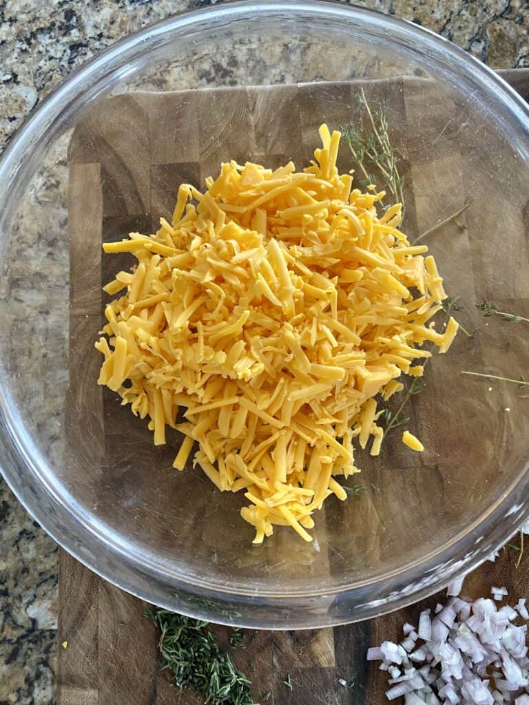 freshly shredded cheese in a bowl for a healthy scalloped potato recipe