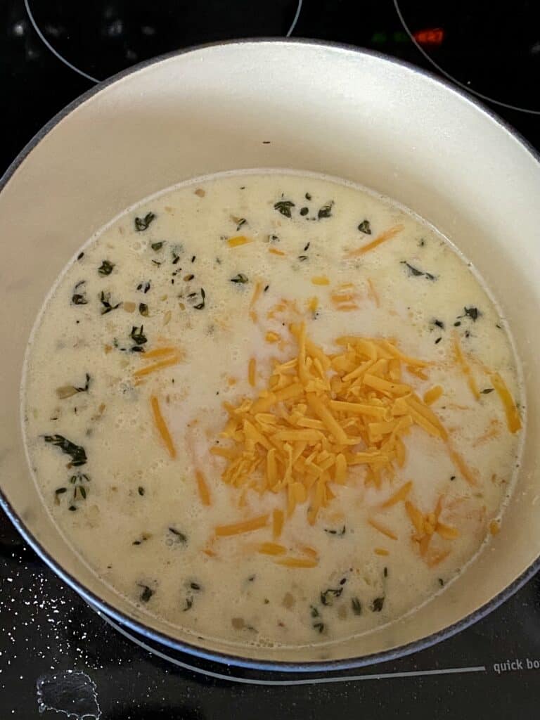 Cheesy cream sauce in a pot for a healthy scalloped potato recipe