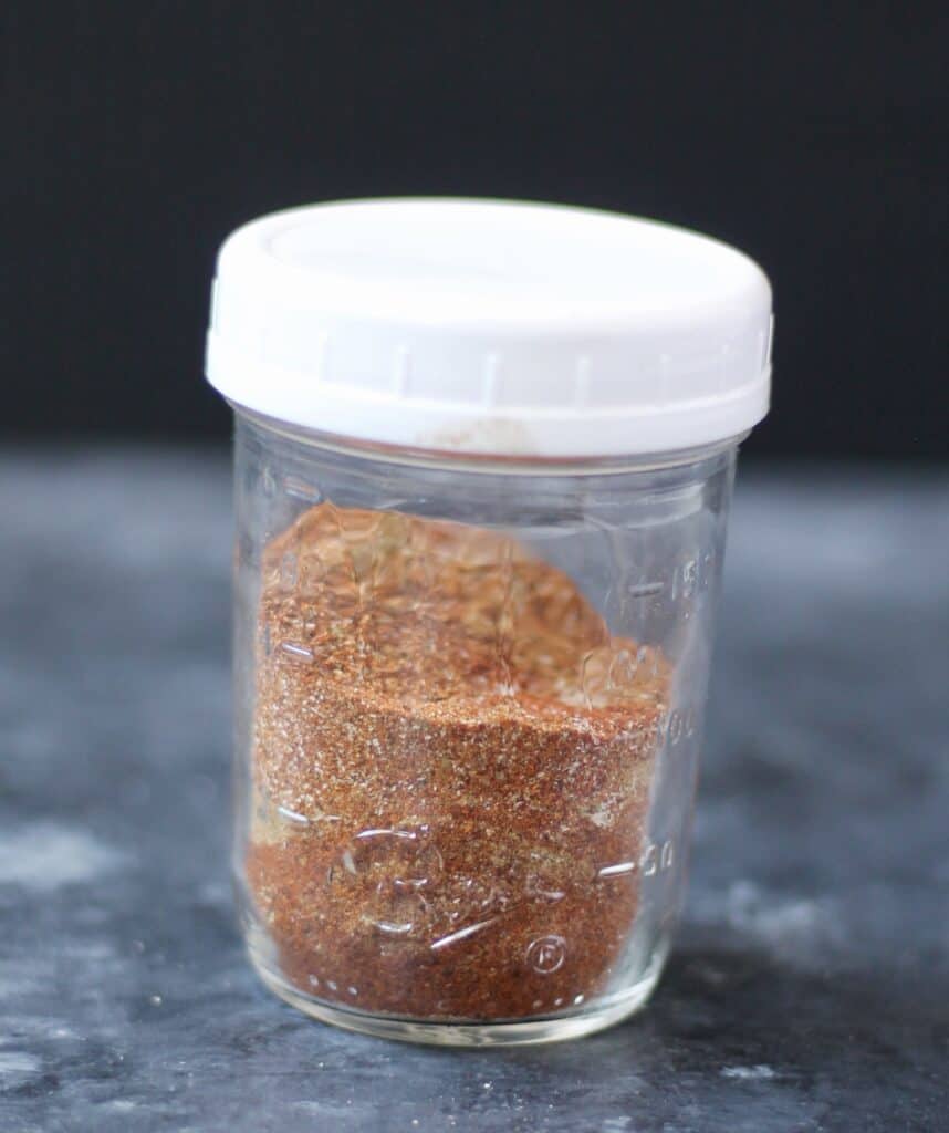 Container of homemade taco seasoning.