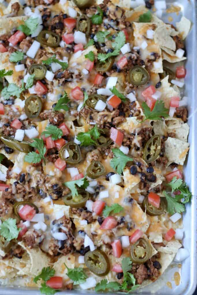 close up of ground turkey nachos freshly made on a baking dish