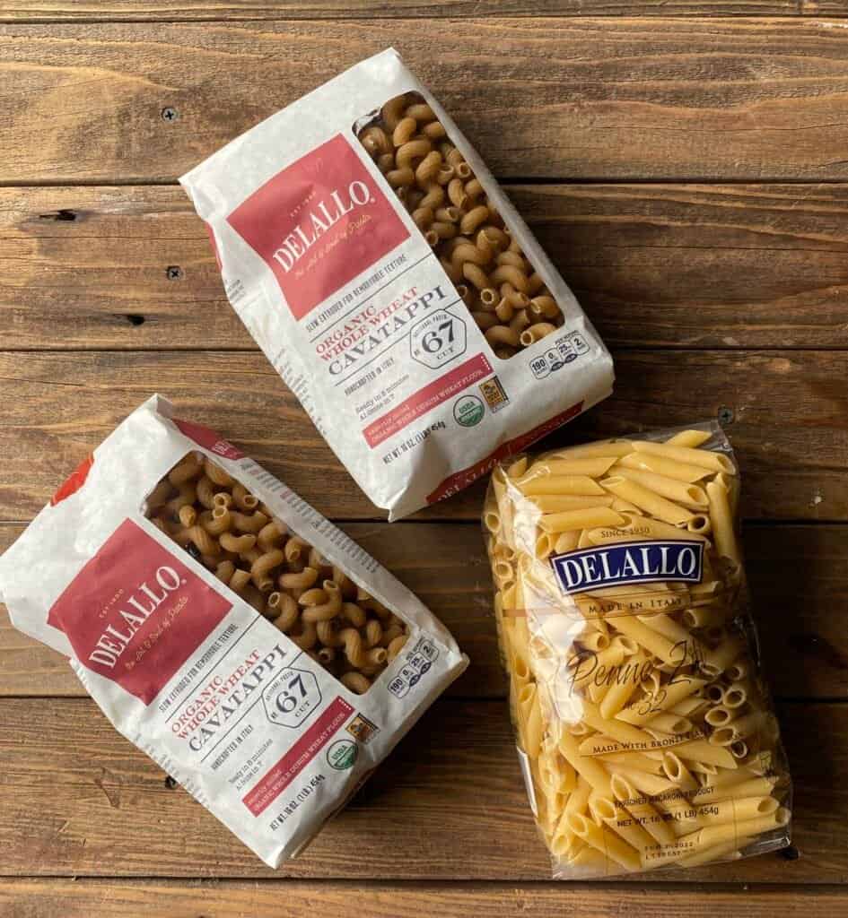 3 bags of Dellalo pasta on a wooden table