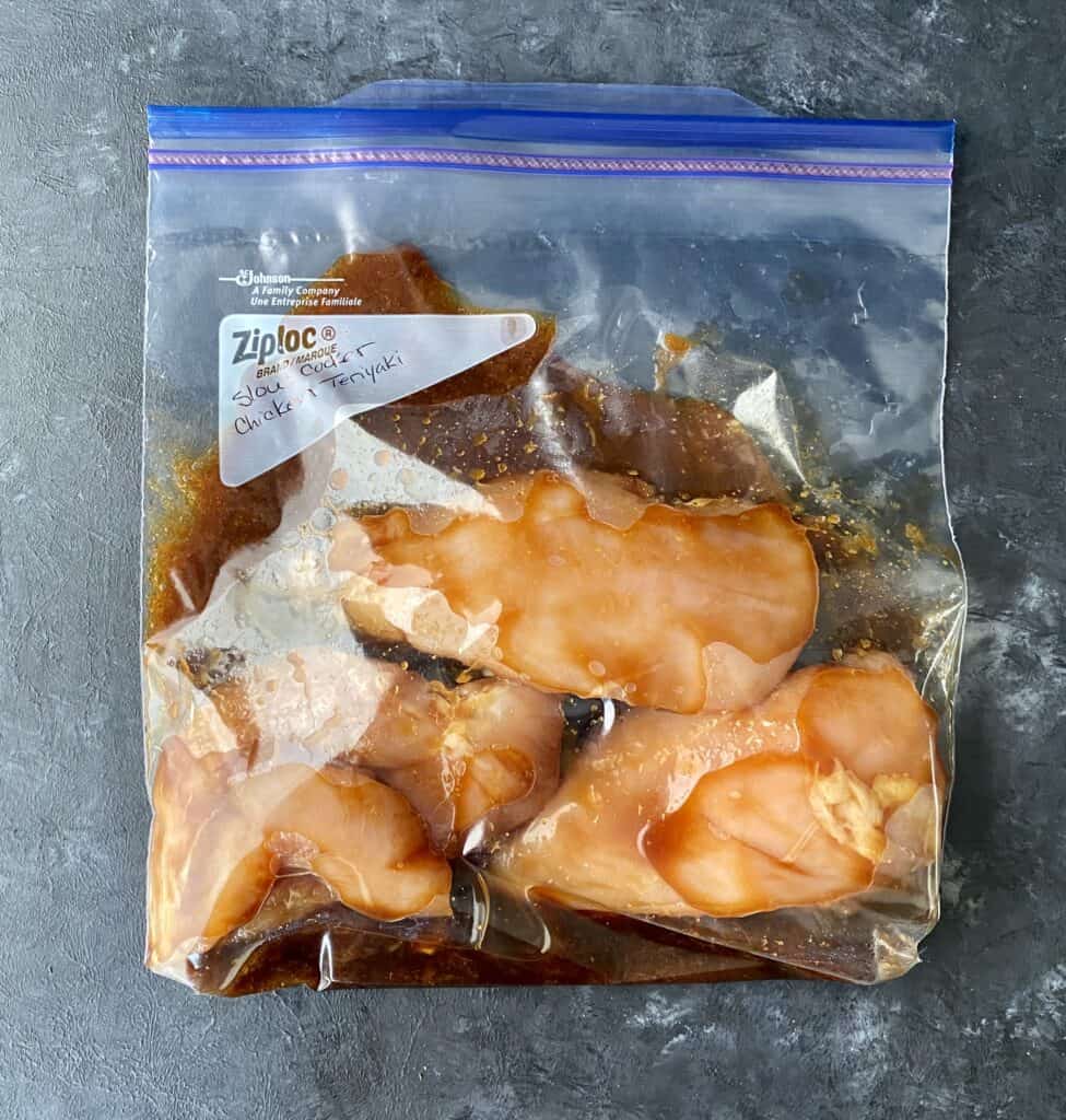 Chicken breasts with terriyaki sauce being prepped for a slow cooker