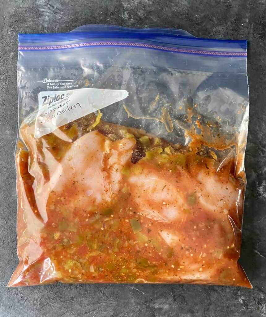 Slow cooker salsa chicken prepped for freezing in a ziplock bag