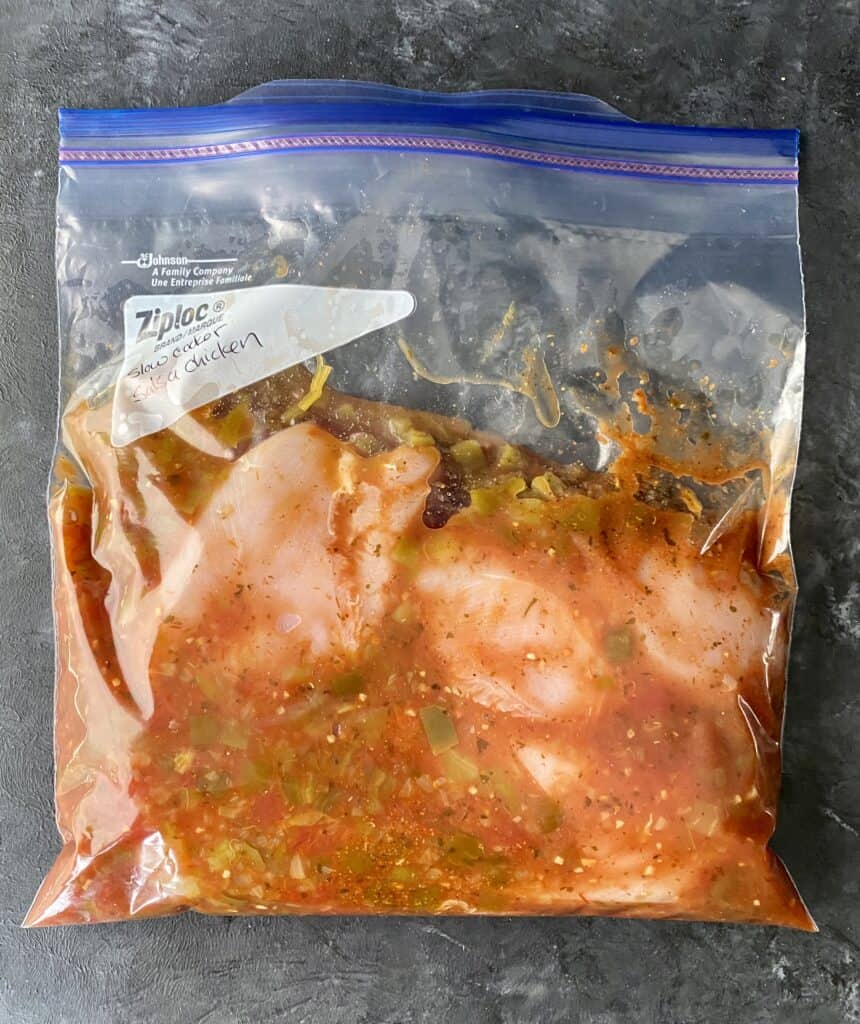 Slow cooker salsa chicken prepped for freezing in a ziplock bag