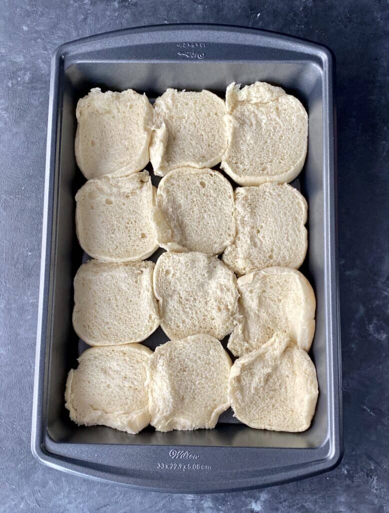 Sliced rolls filling the bottom of a baking dish