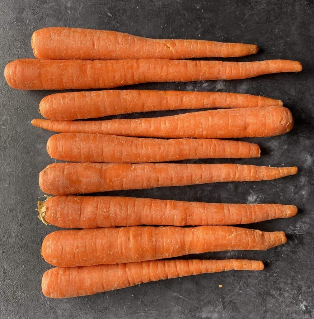 raw carrots on gray table