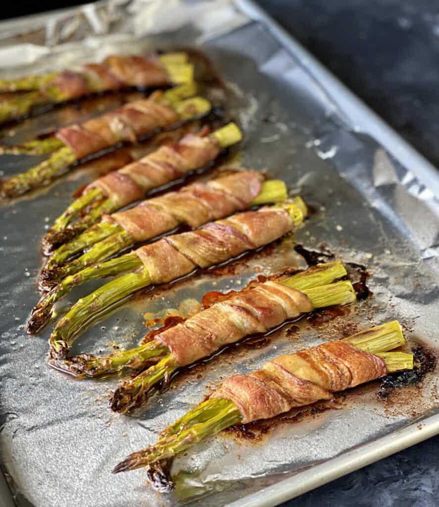 roasted bacon-wrapped asparagus on foiled pan