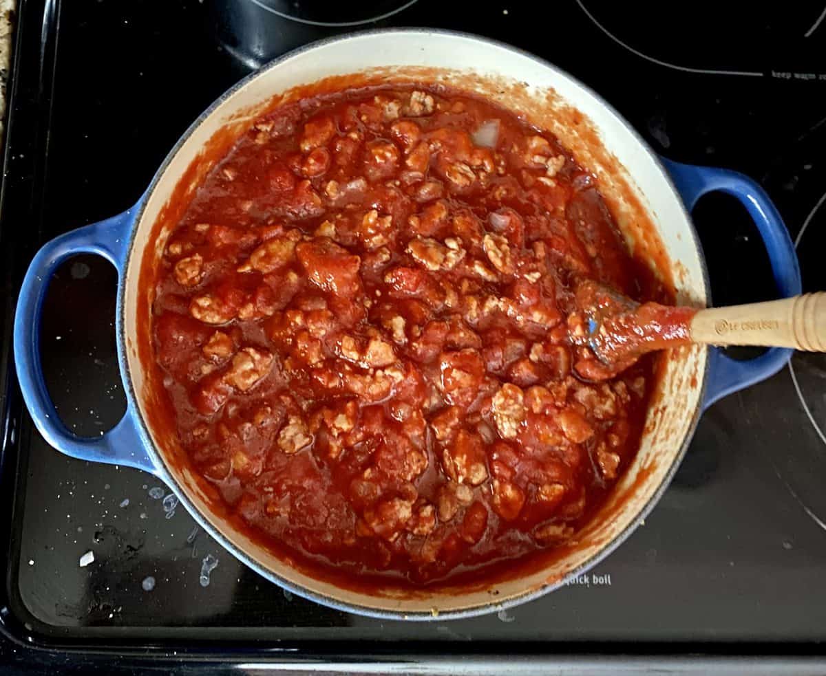 Bolognese sauce base being cooked in a blue pan