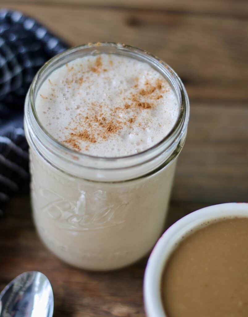 Mason jar with frothy homemade creamer topped with cinnamon