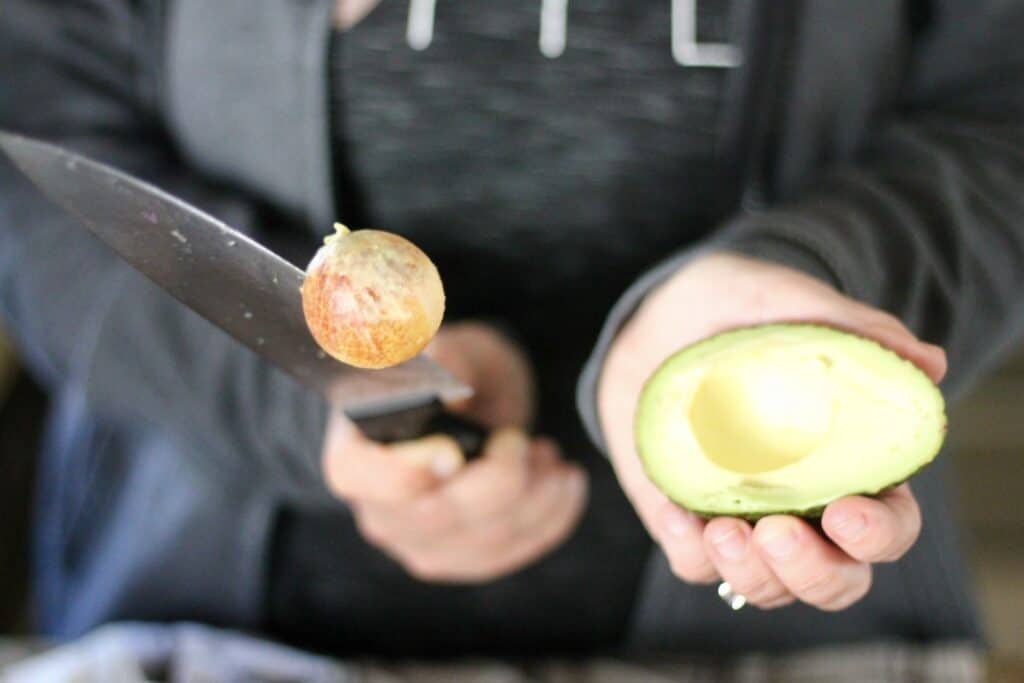 Removing an avocado pit with a knife