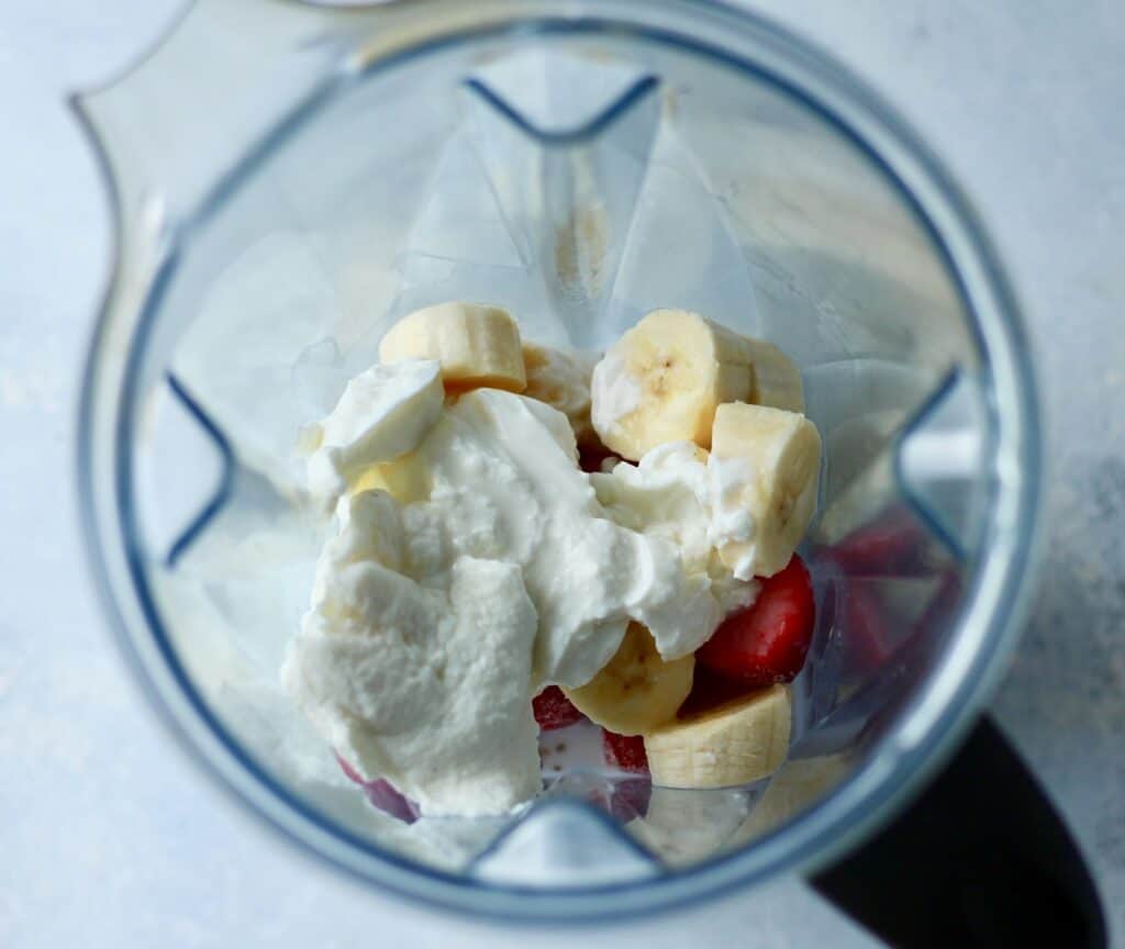 Blender with banana, strawberry and yogurt at the bottom