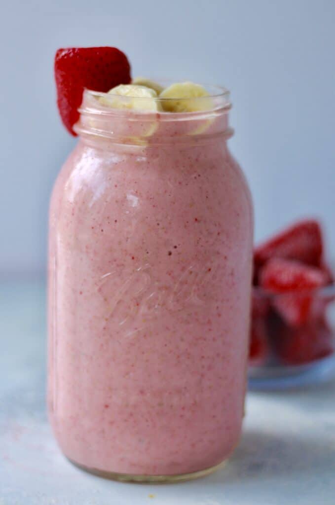 Mason jar filled with strawberry banana smoothie