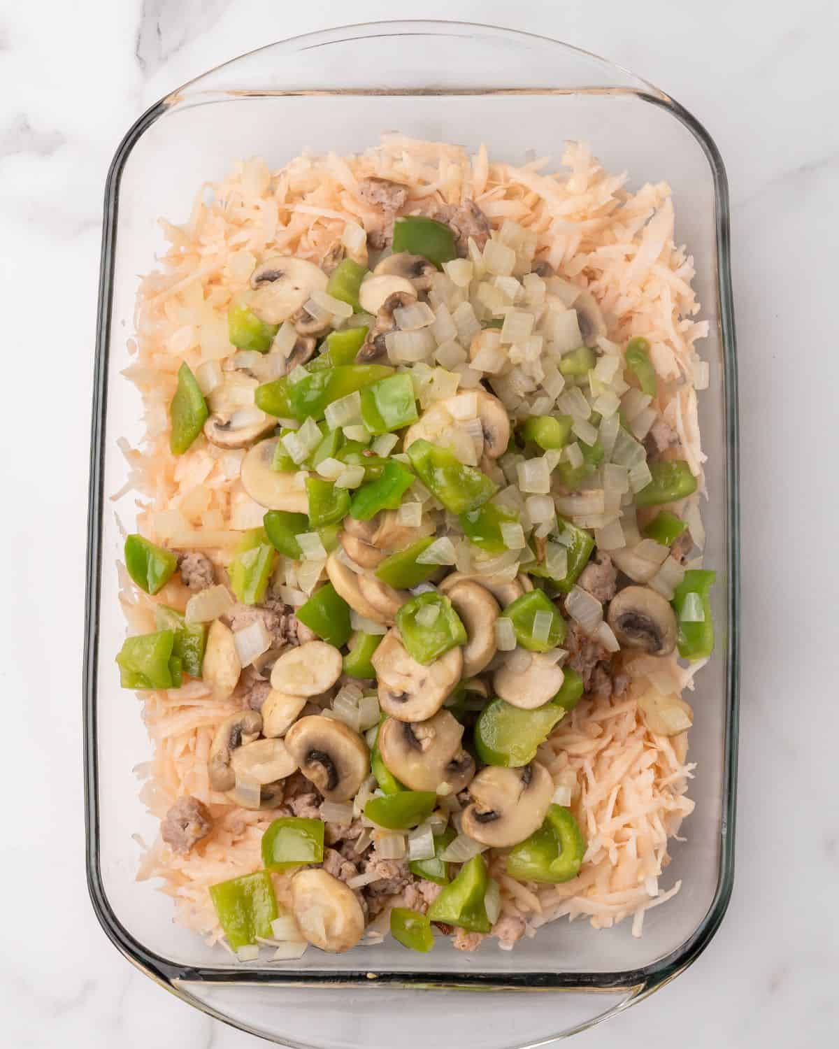 hash browns and veggies in the casserole dish