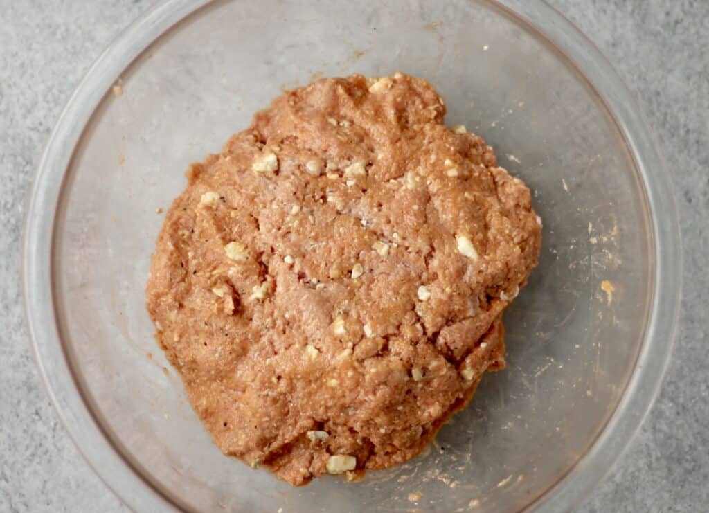 Mixture for buffalo turkey burgers in a glass bowl