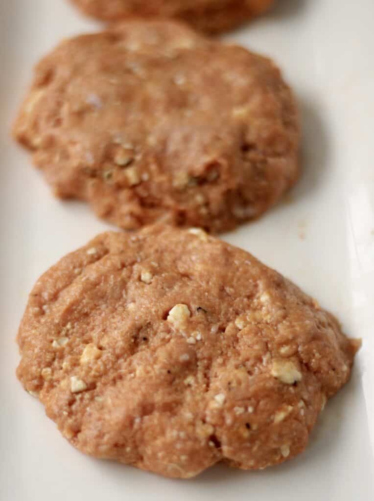 Buffalo turkey burgers on a parchment sheet