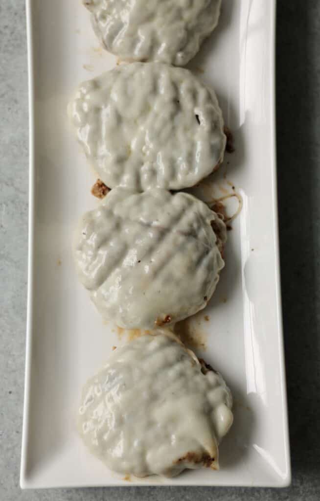 Buffalo turkey burgers covered with a slice of provolone cheese