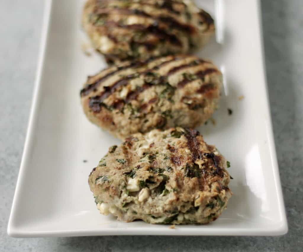 turkey burger patties on a white plate