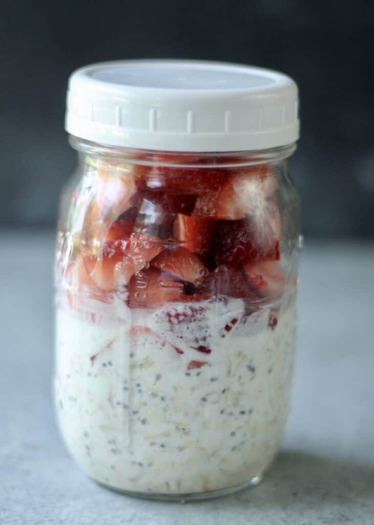 a jar of overnight oats with strawberries.