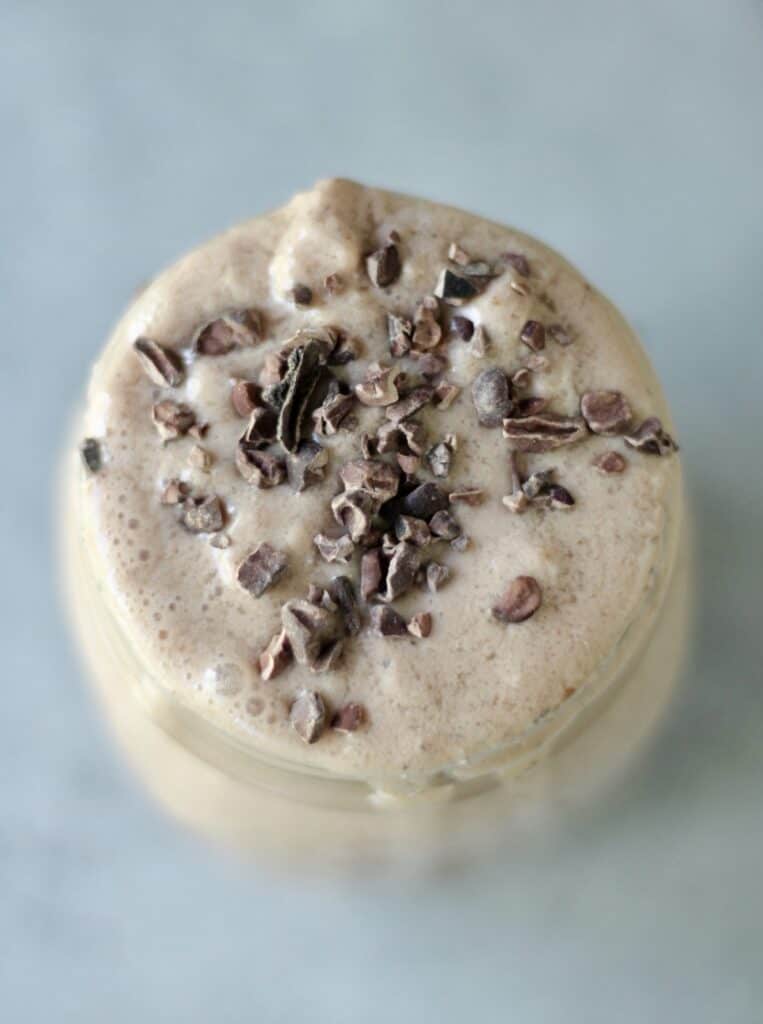 Aerial view of a mason jar filled with a chocolate peanut butter smoothie