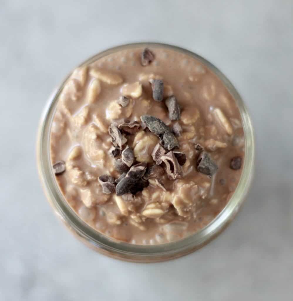 Close up of a mason jar filled with chocolate overnight oats