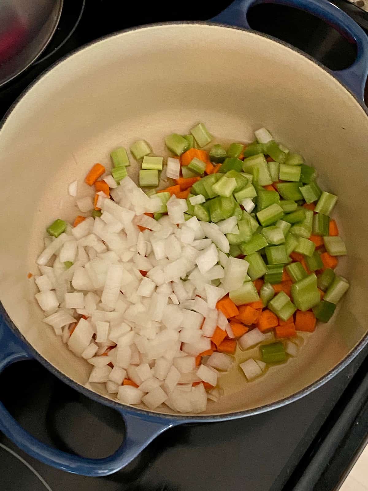 chopped celery, onion, and carrots in a pot