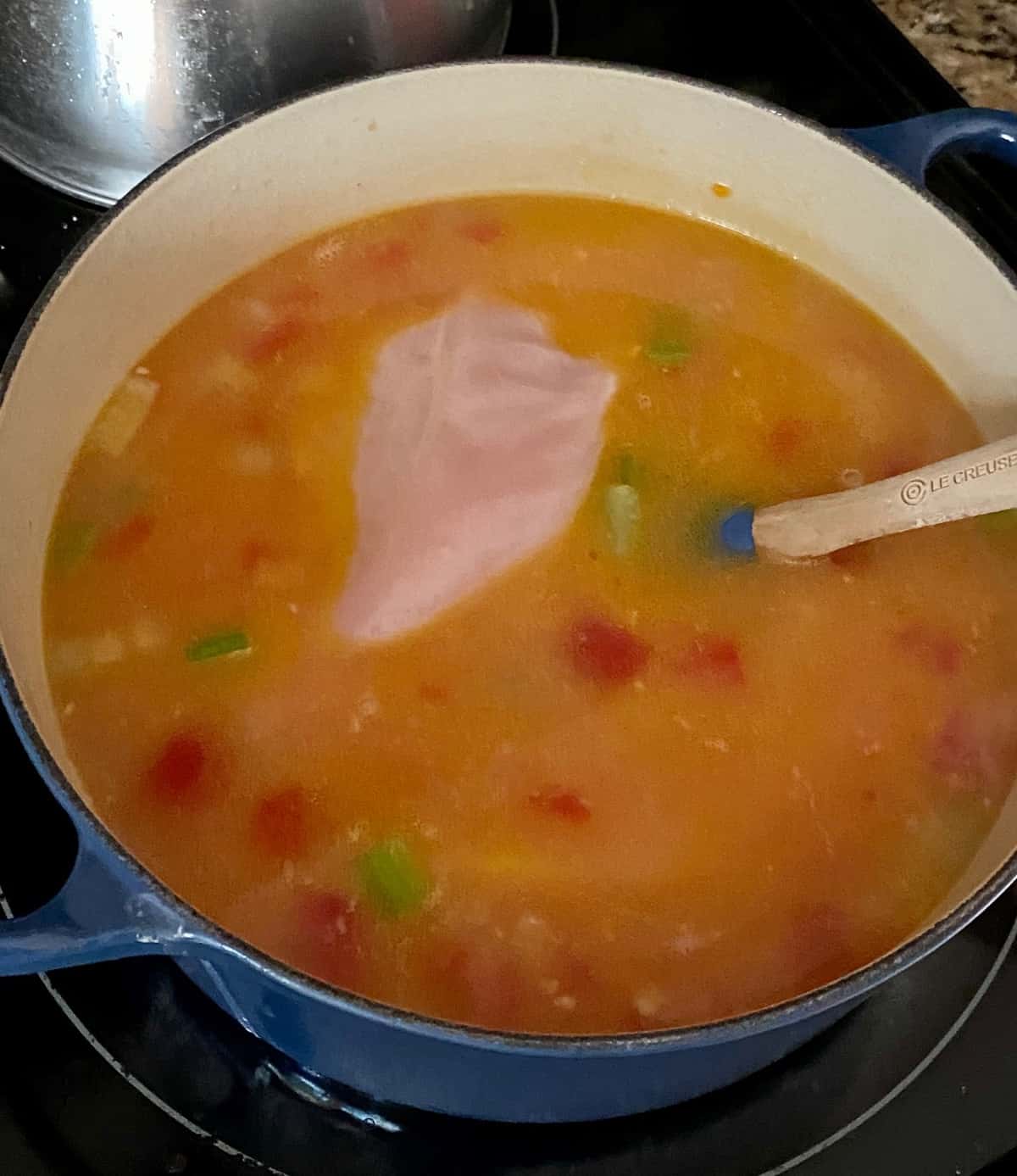 adding in chicken breasts to buffalo soup