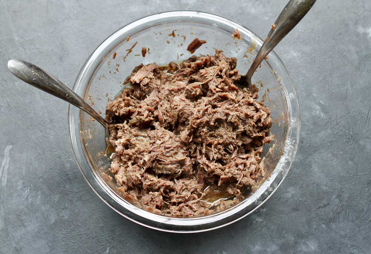 Shredded beef in a glass bowl