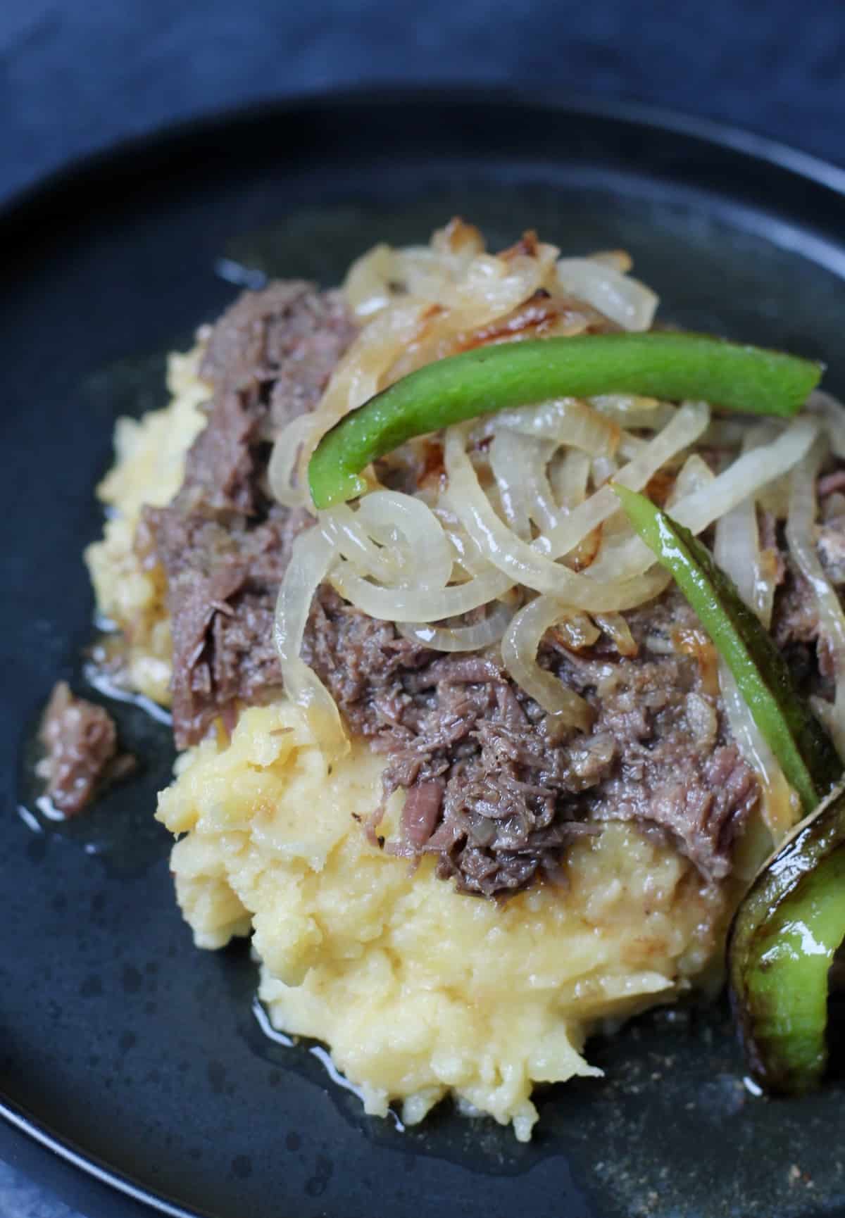 shredded pot roast over a bed of mashed potatoes