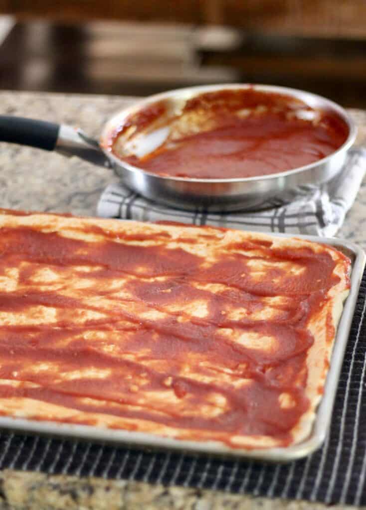 Pizza sauce spread on a wheat dough